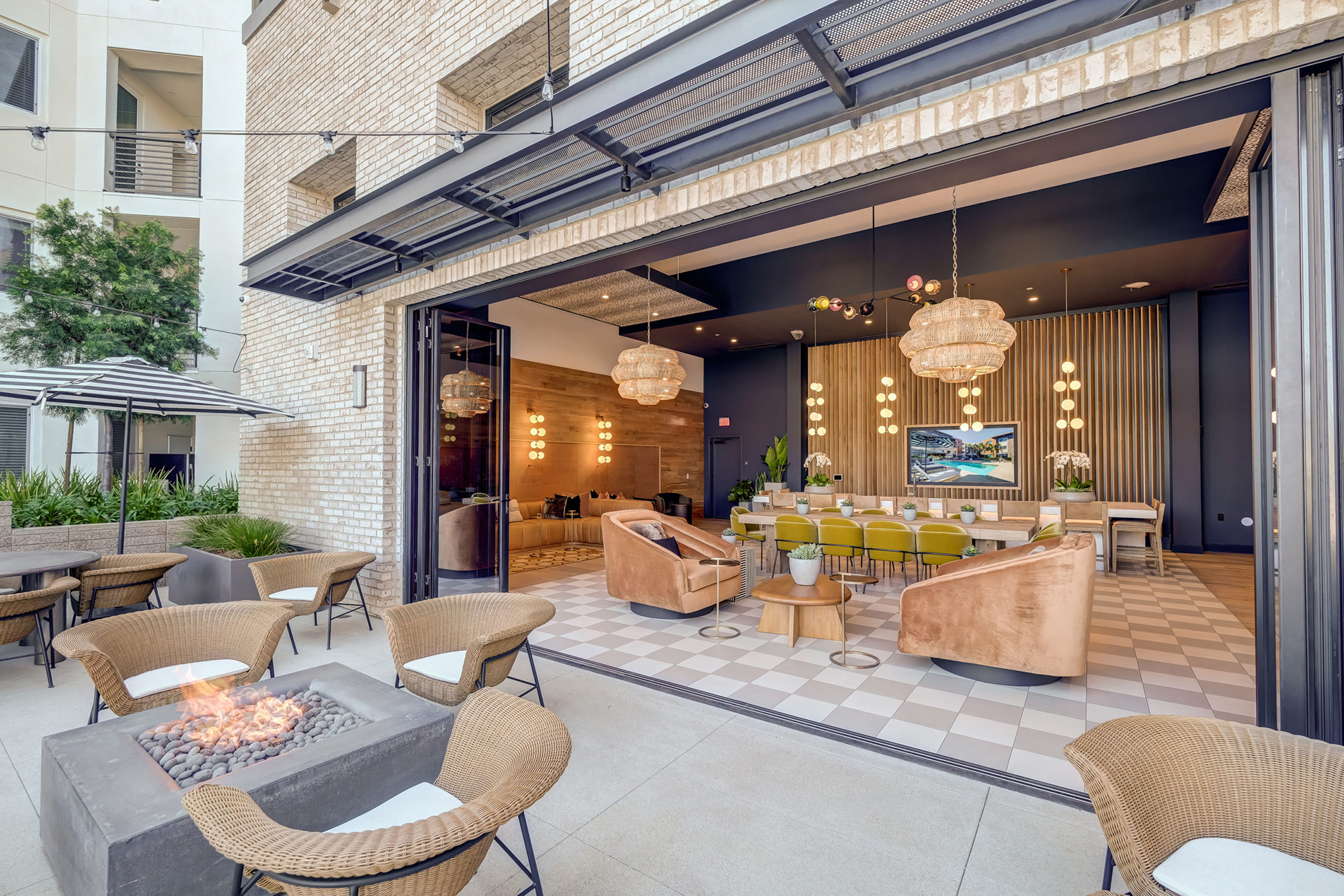 Fire pit and indoor-outdoor lounge area at Alexan NOHO West